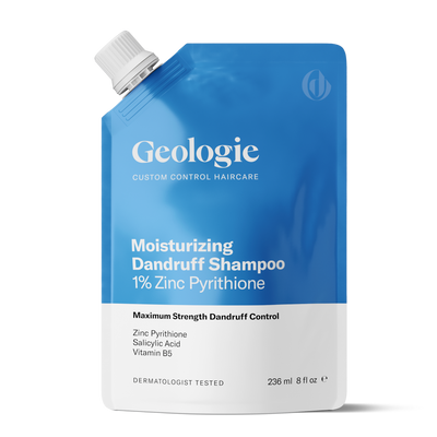 A blue pouch of Geologie Moisturizing Dandruff Shampoo with 1% Zinc Pyrithione, salicylic acid, and vitamin B5. The Geologie Moisturizing Dandruff Shampoo is dermatologist tested and contains 236 ml (8 fl oz) of product, promising soothing dry scalps and flake-free locks.