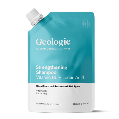 A teal pouch labeled Strengthening Shampoo from Geologie features Vitamin B5 and Lactic Acid, formulated to deep clean and restore all hair types. It has a capacity of 236 ml (8 fl oz).